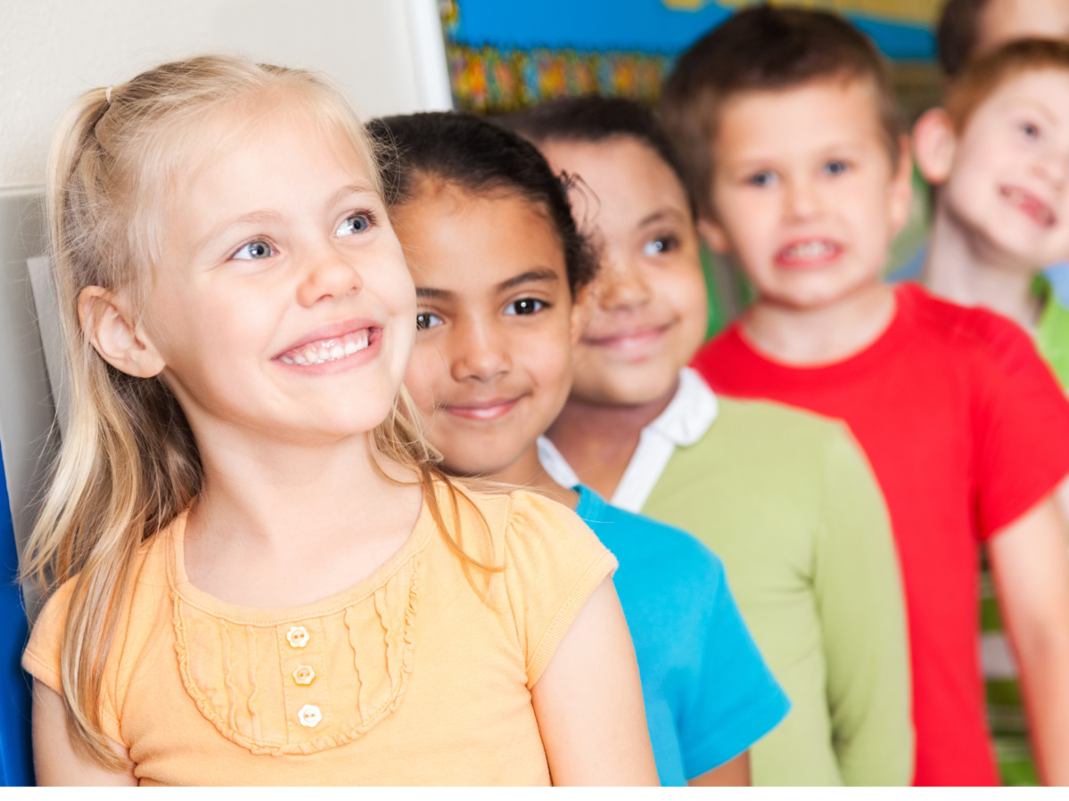 Smiling students standing in a line.