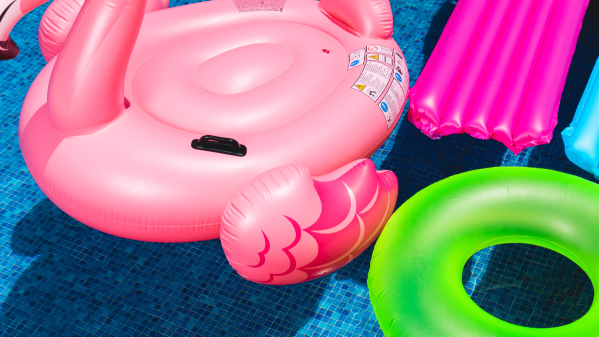 Pool toys and floaties floating in a pool.