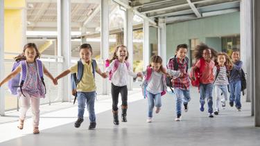 Elementary kids - Kindergarten Registration Young kids holding hands running down the hall