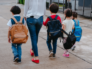 Children walking to school with a parent.