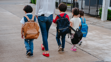 Children walking to school with a parent.