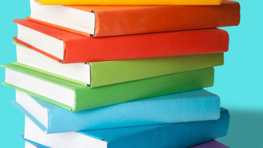A stack of rainbow-coloured books.