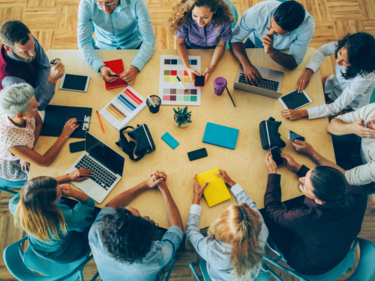 Adults sitting around a table at a meeting.