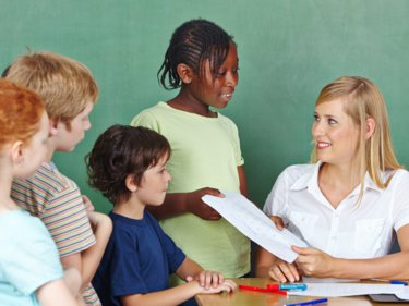 Students talking with a teacher.