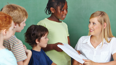 Learning Updates Go Home Students talking with a teacher.