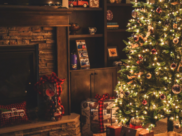 Christmas tree, presents and a fireplace.