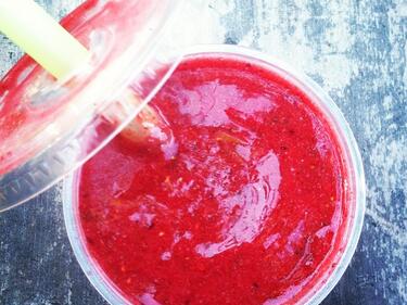Red smoothie with lid slightly off