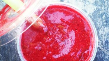 Red smoothie with lid slightly off