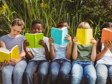 Five children reading different coloured books.