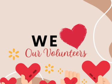 We Love Our Volunteers sign with hearts in hands.