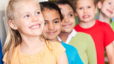 Temporary Grade Groupings Smiling students standing in a line.