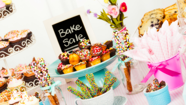 Bake Sale Bake sale items on a table with a sign.