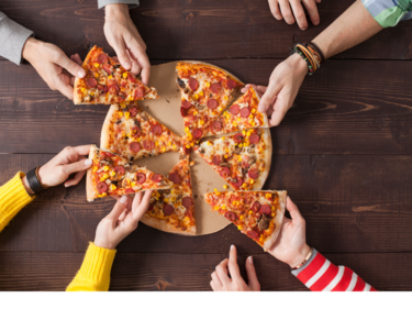 Children reaching for slices of pizza.