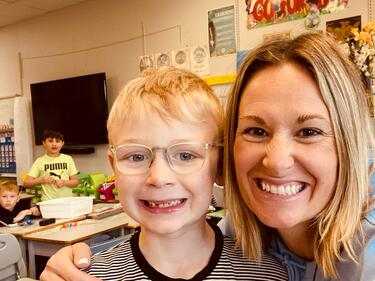 A teacher and her student in a classroom.