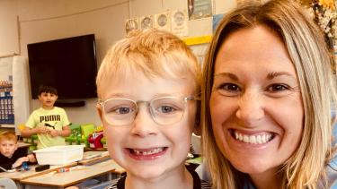 A teacher and her student in a classroom.