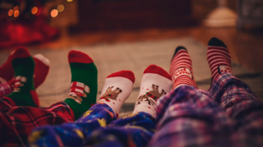 PJ Day The legs in family members in pjs with Christmas socks.