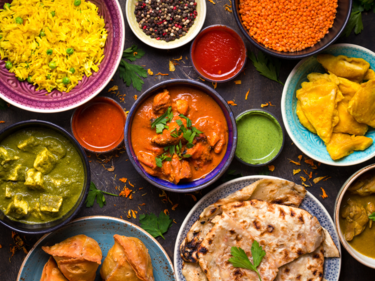 Indian foods in coloured dishes.