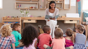 Teacher reading to children.