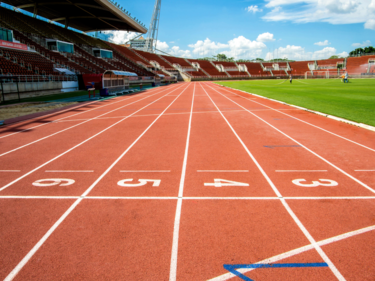 A stadium with a track and grass field.
