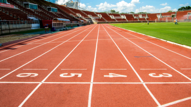 A stadium with a track and grass field.