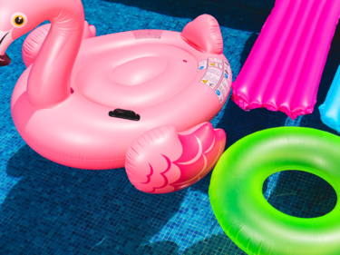 Pool toys and floaties floating in a pool.