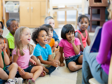 Happy children sitting in a row.