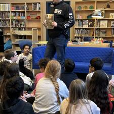 Constable Neil Cole sharing a book with students.