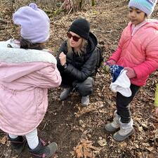 Teacher working with students in the forest.