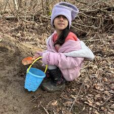 Student digging in the dirt.