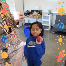 A student choosing fruit to add to a smoothie.